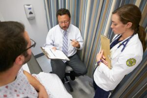 Teacher working with a PA student in a clinical setting