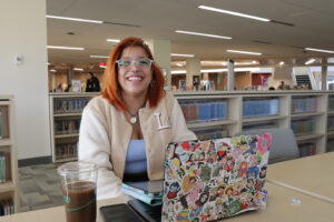 Female student in the library with laptop