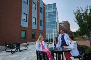PA Students around a table outside of the Science Center at Le Moyne College