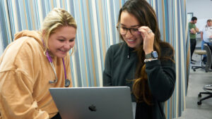 Nursing students working on a laptop