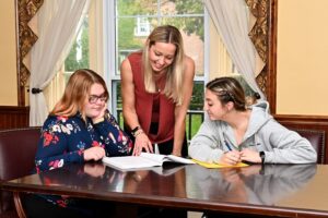 Clinical Mental Health Counseling Students working together at a table.