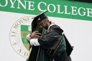 President Linda LeMura congratulates a graduate