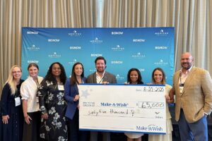 Ryan Chismark presenting check to Make a Wish Foundation