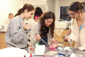 Three female students in a lab